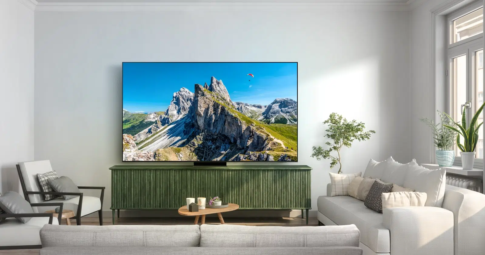 telewizor Samsung QLED stoi na szafce RTV w jasnym i nowoczesnym, lecz przytulnym salonie